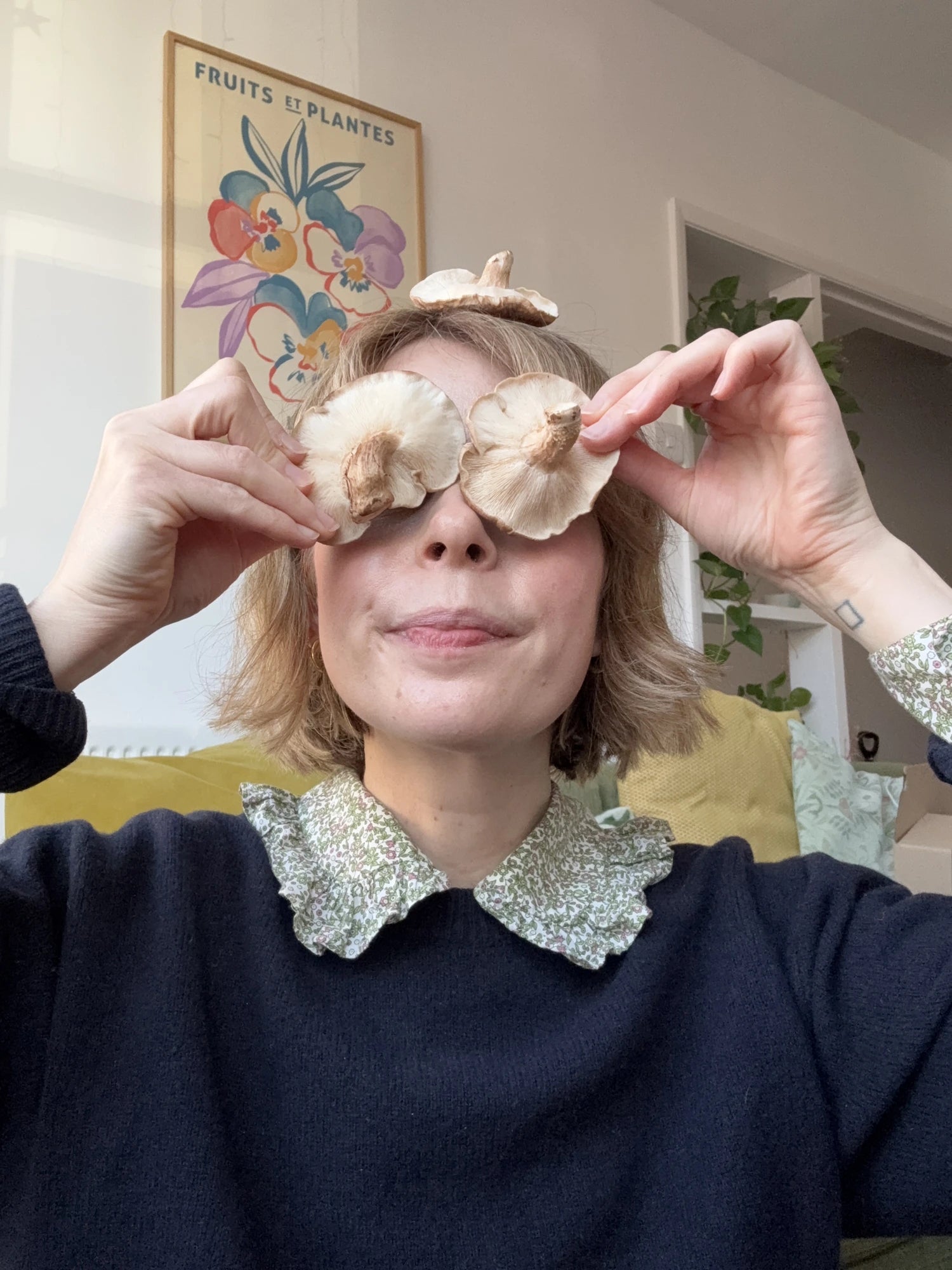 Janina Fleckhaus, Luma’s founder, holding mushrooms in front of her eyes.