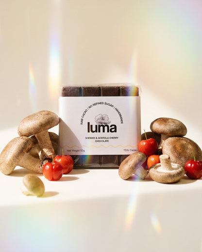 Luma chocolate bar with mushrooms and acerola cherries on a light background