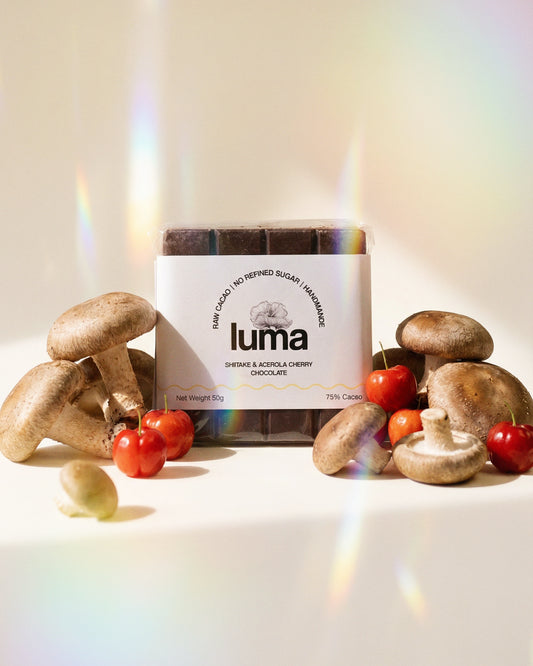 Luma chocolate bar with mushrooms and acerola cherries on a light background